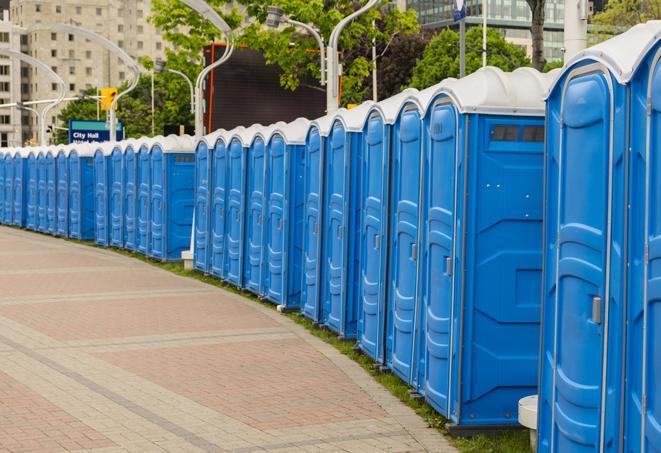 a row of portable restrooms set up for a large athletic event, allowing participants and spectators to easily take care of their needs in Bradley Beach